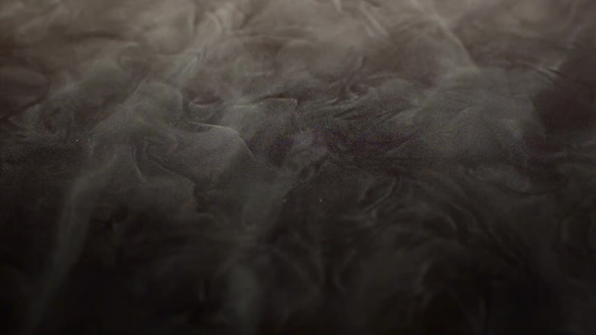Abstract smoke passing over the ground in slow motion