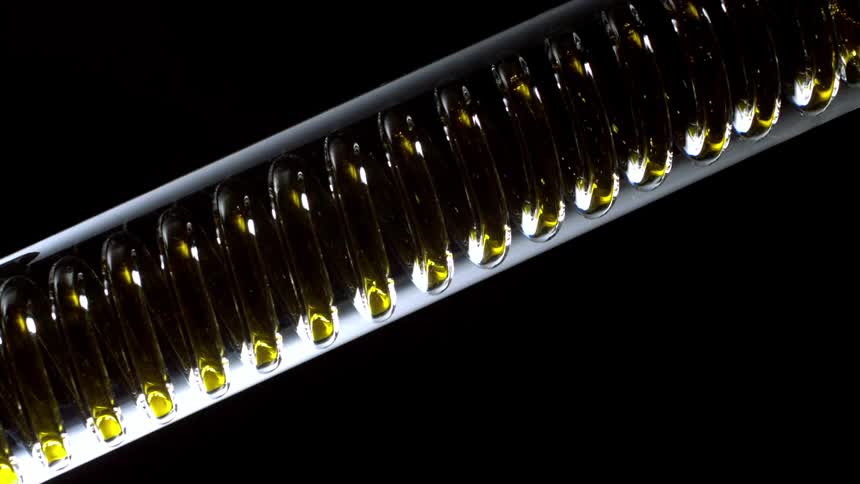 Yellow fluid flowing through a spiral pipeline