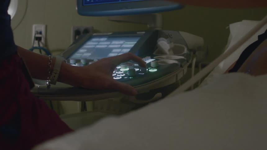 A woman is operating a medical device