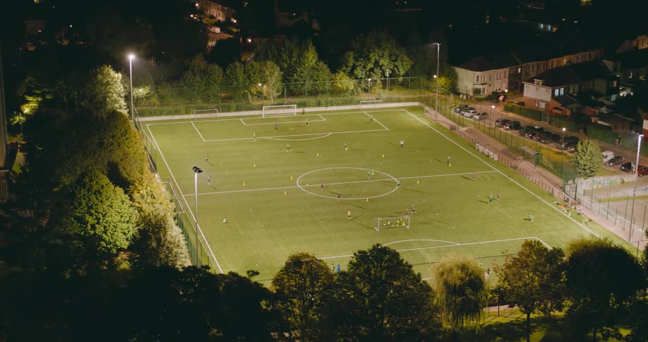 Aerial of a football field in an urban city at night