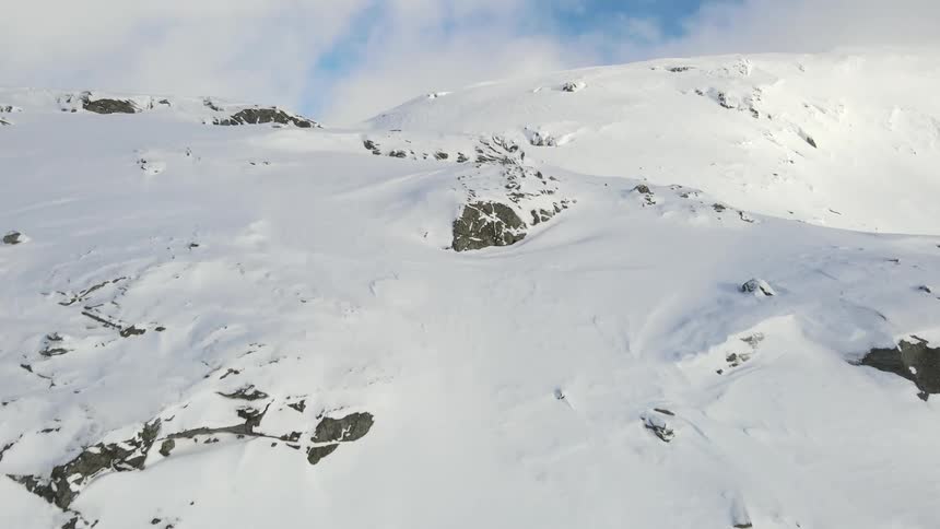 Aerial of glacial rocky mountain peaks during daytime