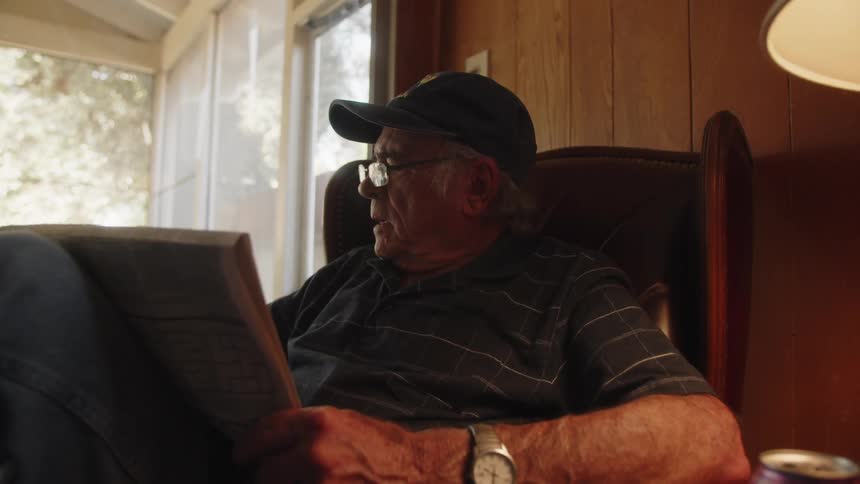 A man is reading a newspaper