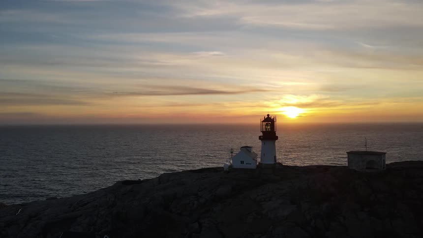 Panorama of a fort on the coast facing the sea with the sunrise on the horizon