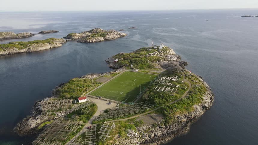 Aerial view of a football field in the middle of an island by the sea