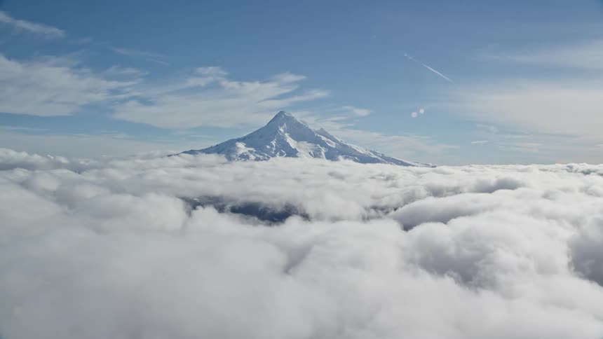 The mountain rises above the clouds