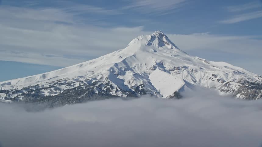 Mountain covered by snow on a blue sky day
