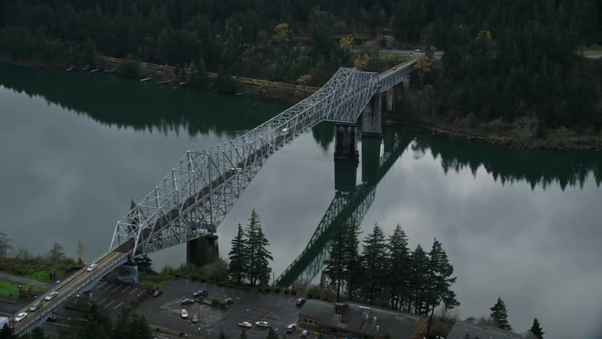 Aerial view of a bridge connecting a city over a lake