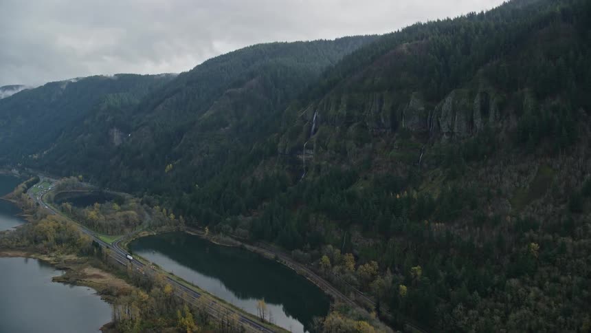 Aerial of a waterfall on a mountain falling into the lake