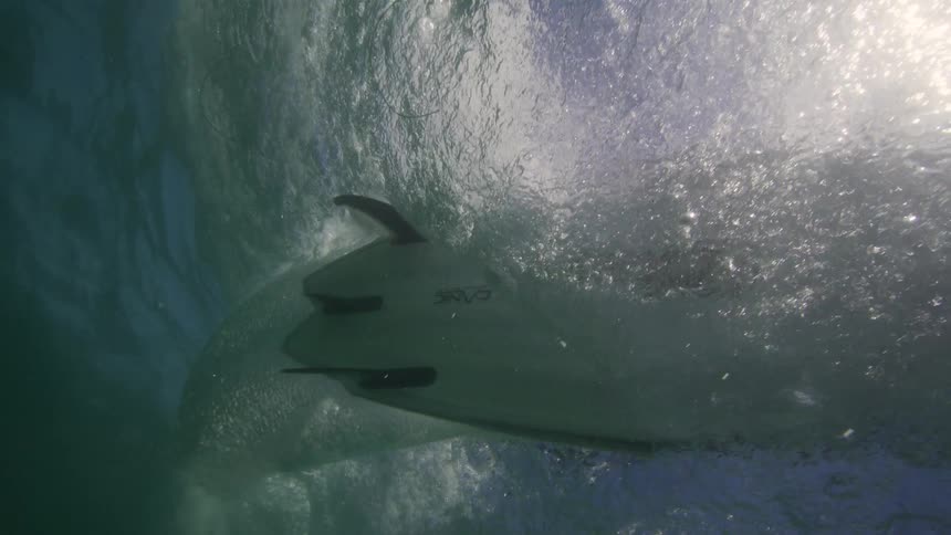 View from underwater as water splashes and a boat moves overhead