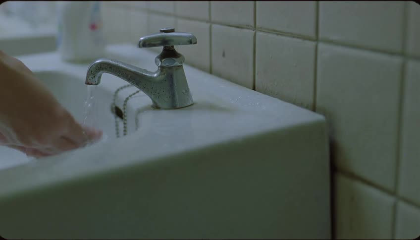 Close up of a person washing his hands in the bathroom