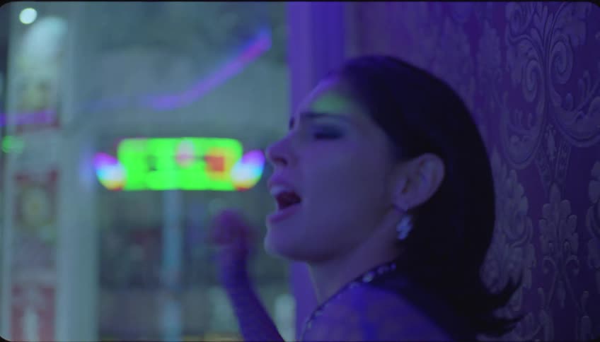 Group of friends singing karaoke on a night club