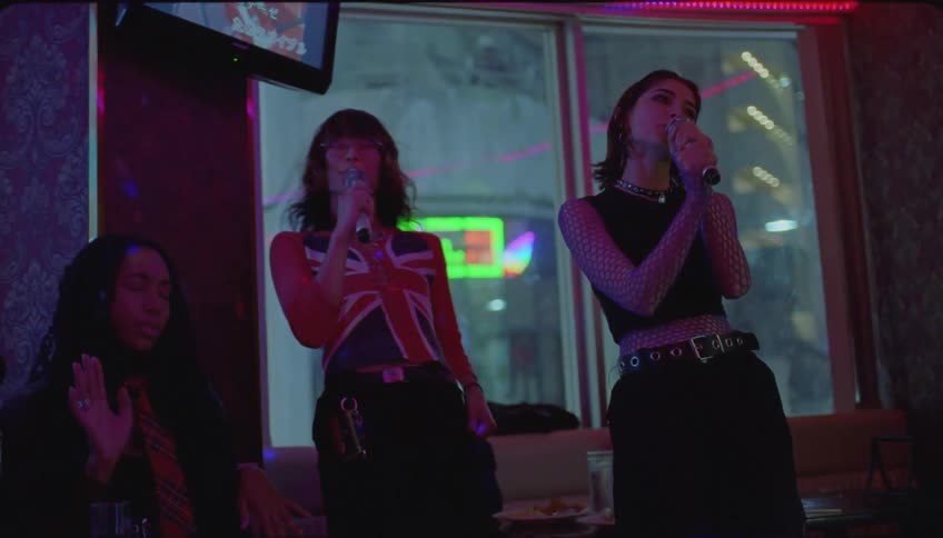 Friends singing at a karaoke in the night bar