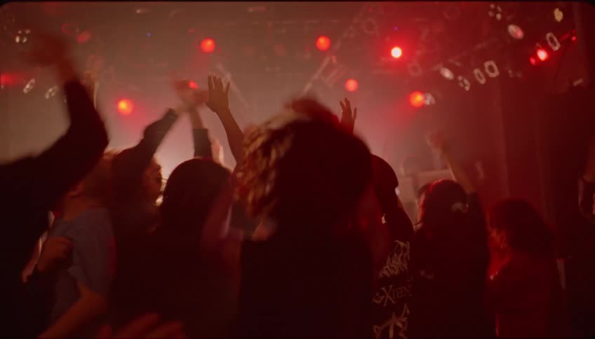 Woman entering a nightclub and dancing vibrantly