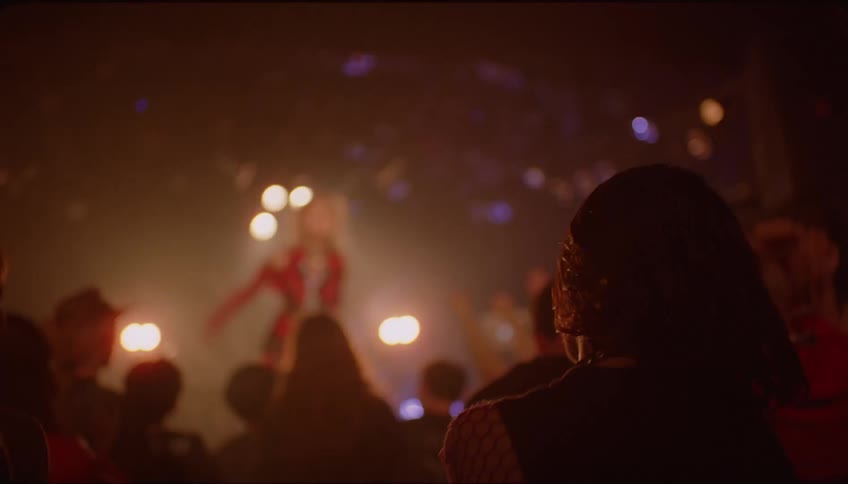 Young woman dancing and having fun at a concert