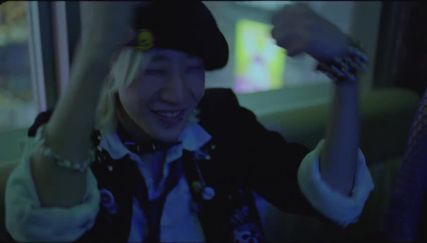Friends in a nightclub happy while dancing and singing karaoke