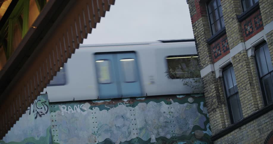 View of a train passing next to a residential building