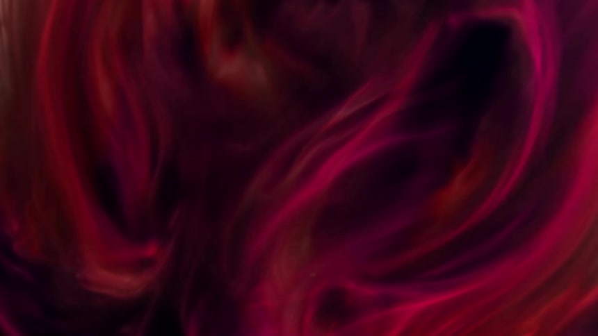 Red and purple gaseous mixture flows and spreads against a black background