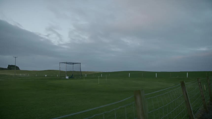 Field of grass enclosed on a cloudy day