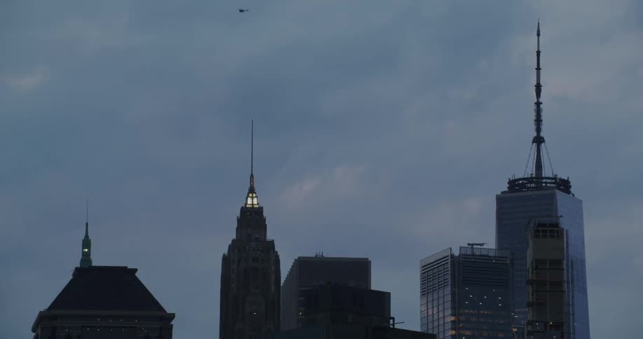 The clouds flow over the tall buildings