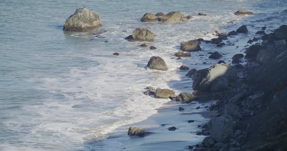 Ocean waves breaking against a rocky shore