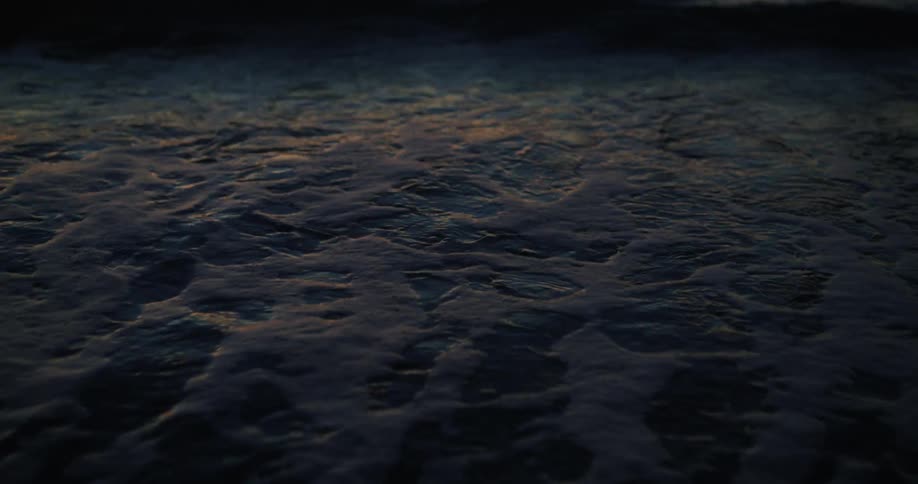 Waves roll over the beach with the tide