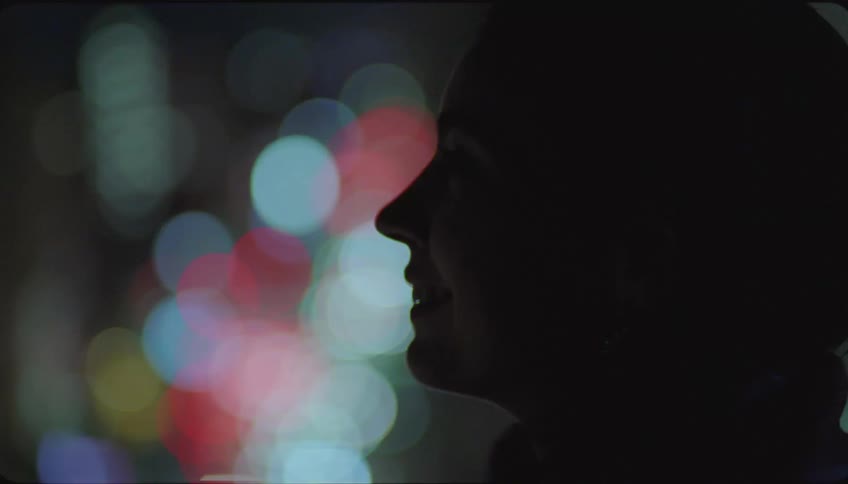 Silhouette of a woman talking in the city at night