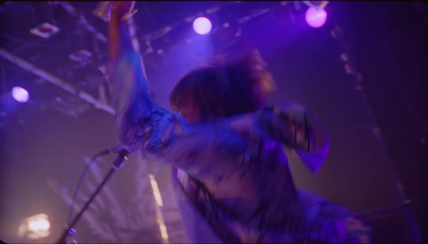 Man singing and performing energetically in a nightclub