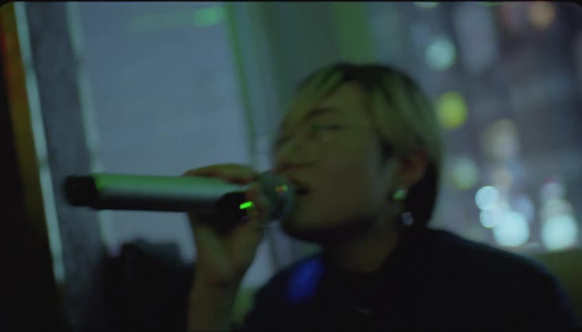Friends smile while singing together in a karaoke room