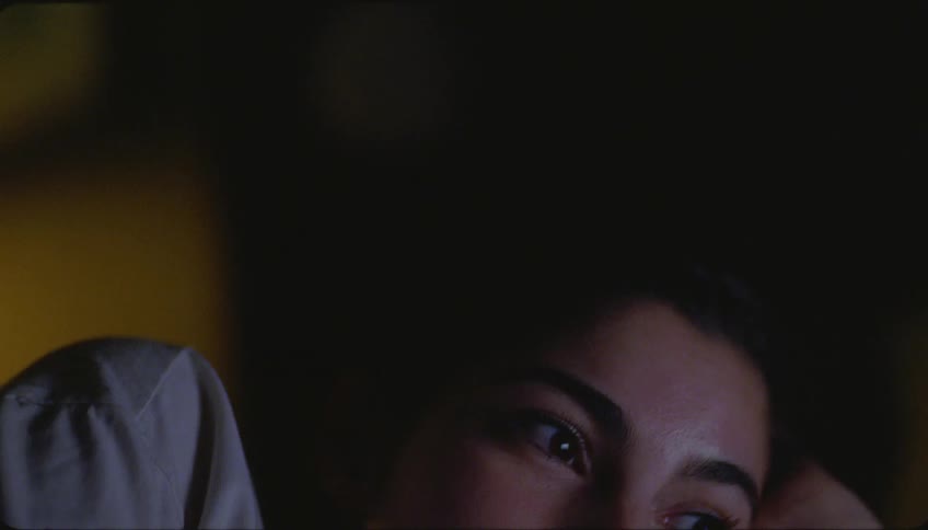 Portrait of a young woman with a happy facial expression while watching something