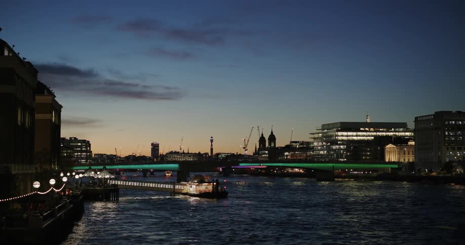 A boat is docked by the pier at sunset