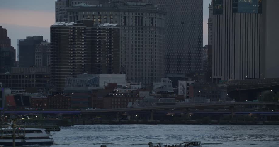 Yacht sails on a river in the city at evening