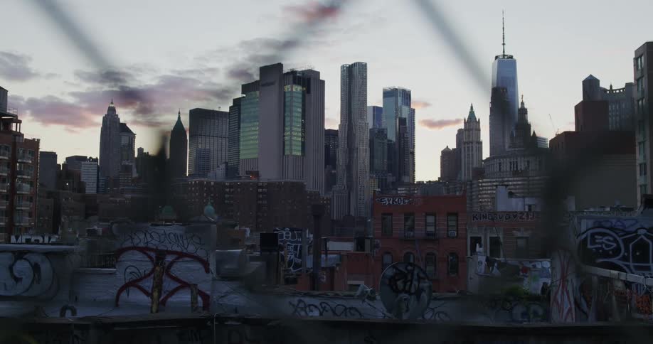 Panorama of a city with graffiticovered walls and skyscrapers on the horizon on a cloudy day