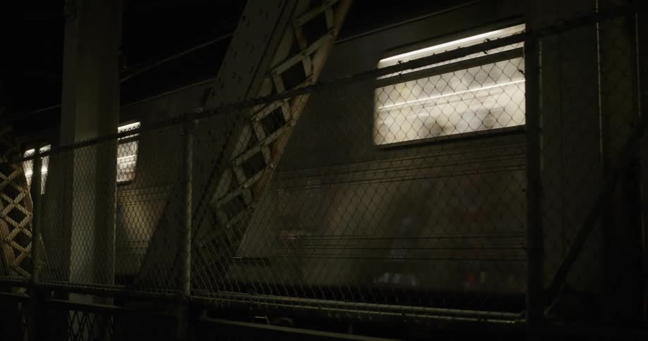 A passenger train glides along the tracks