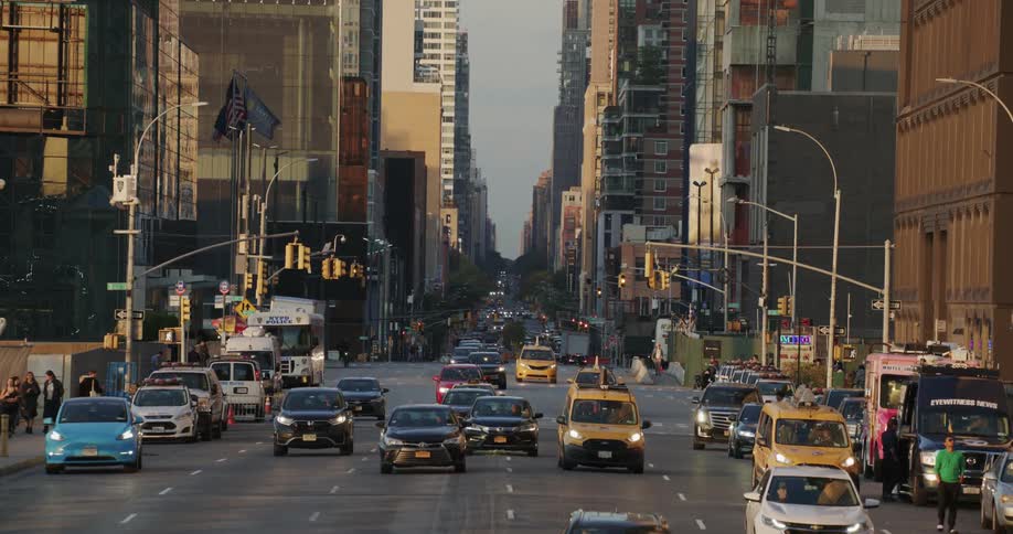A busy city street filled with cars buses and cyclists