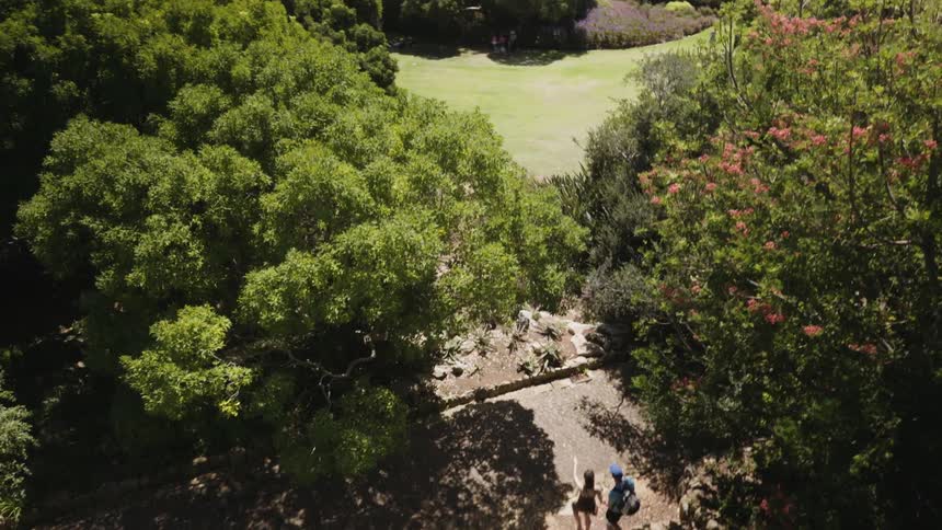 Two people walk towards the stream below