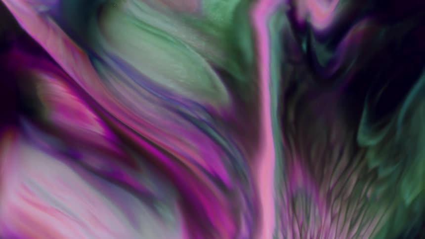 Extreme closeup of a dense and psychedelic colored fluid in motion