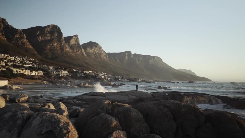 Ocean waves wash ashore a rocky beach