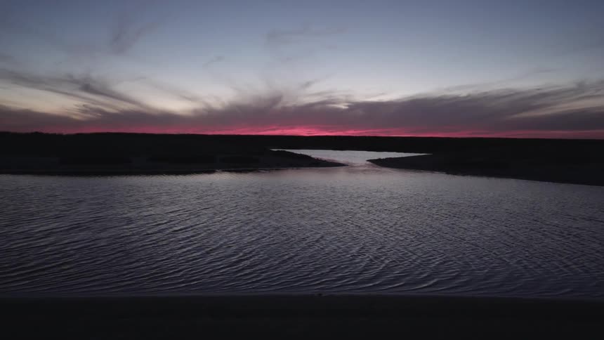 The lake ahead has ripples at sunset