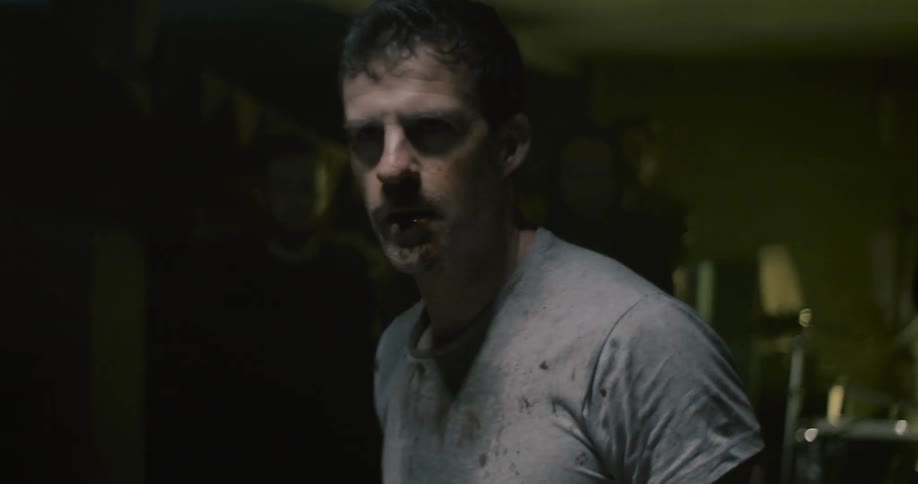 A man gets up injured and breathing heavy
