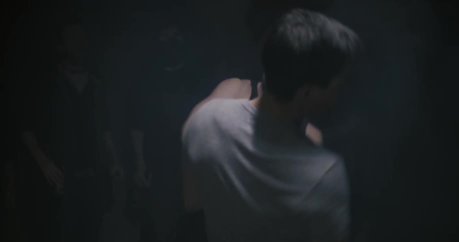 Two men fight under a light