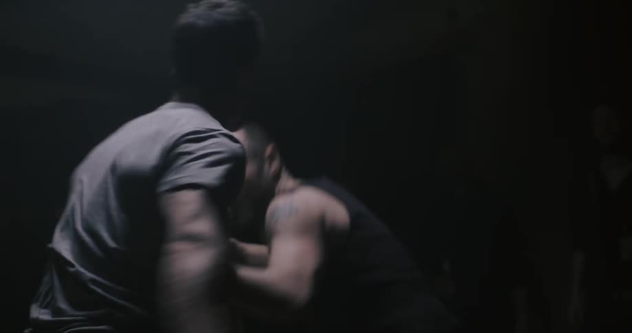 Two men punch and swing at each other