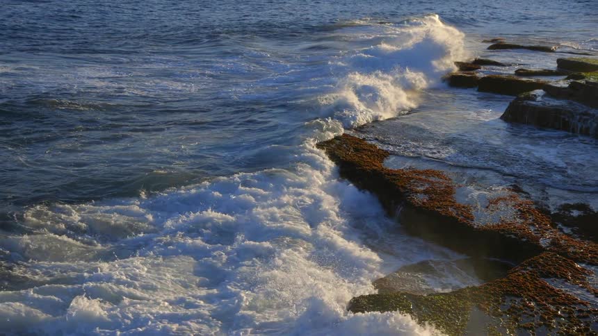 Ocean waves crash ashore