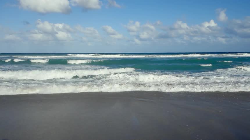 Waves roll onto a beach