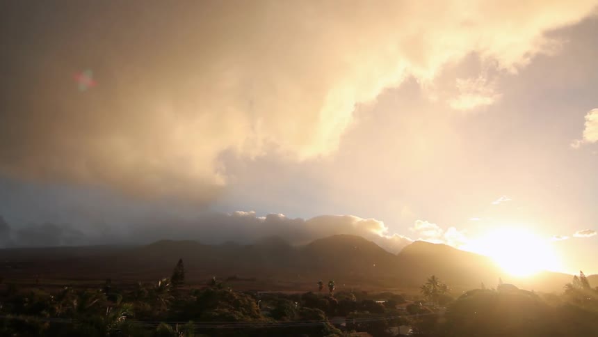 The sun rises on a cloudy day