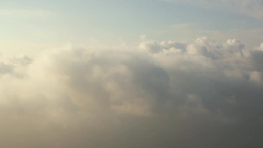 Fluffy clouds float in the sky