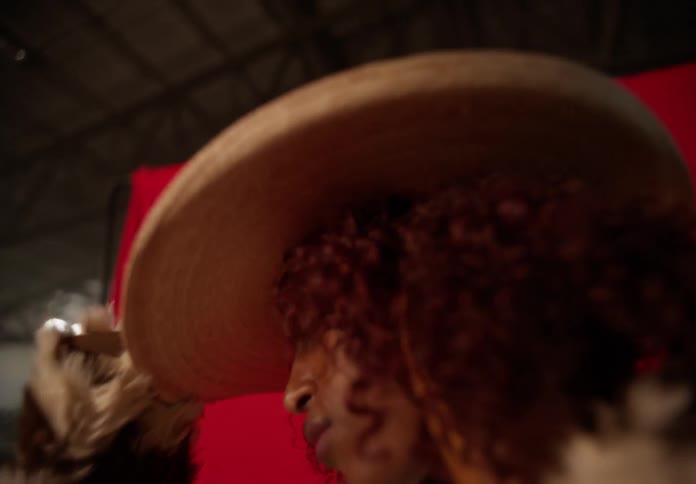 Portrait of a woman posing in a cowgirl hat and outfit