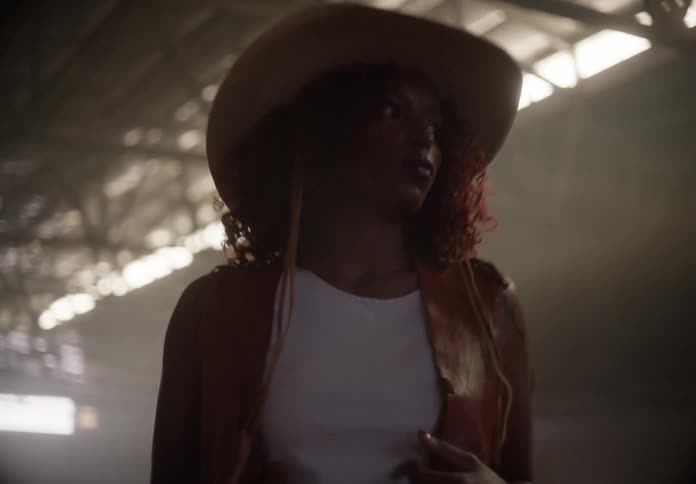Woman modeling clothes inside a large hangar