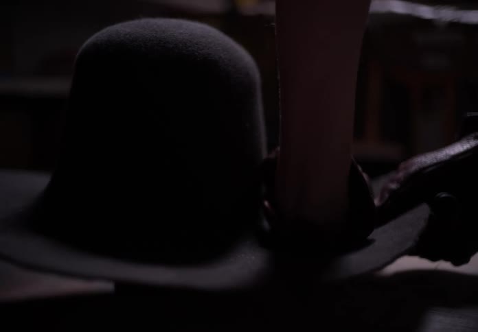 A person making a hat in a factory