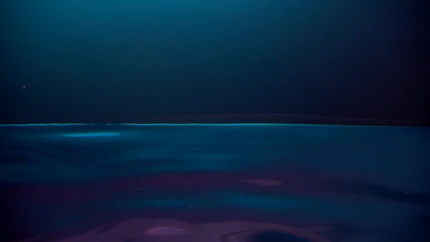 Moving neon lightened water surface
