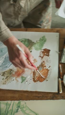 Artist mixing paints with a brush
